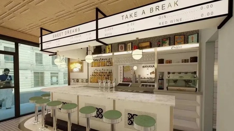 The counter at Old John's, white marble counter, green and chrome stools and white lighting