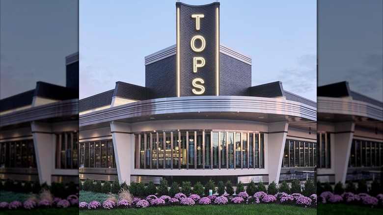 The exterior of Tops Diner, it has a 50's aesthetic and purple flowers along the outside wall