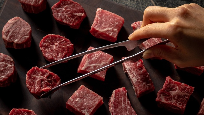 raw beef tongs hand