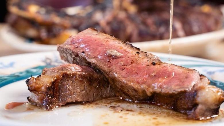 sliced steak sauce pour