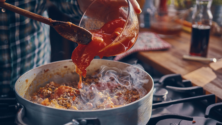 sauce being added to pasta