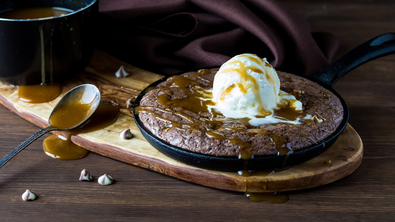 a skillet brownie topped in ice cream