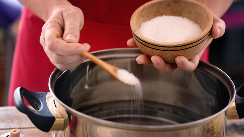 salt being added to pasta water