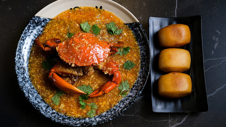 A plate of Singapore chili crab with a side of mantou
