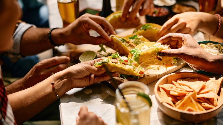 Diners eating tacos at a restaurant