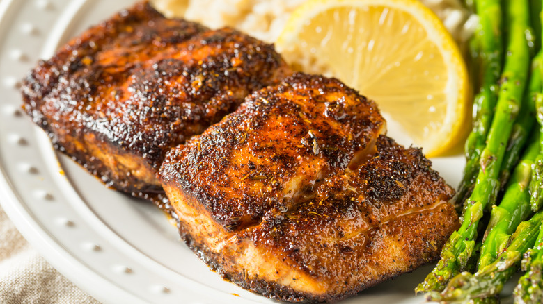 Blackened mahi mahi with lemon and asparagus.
