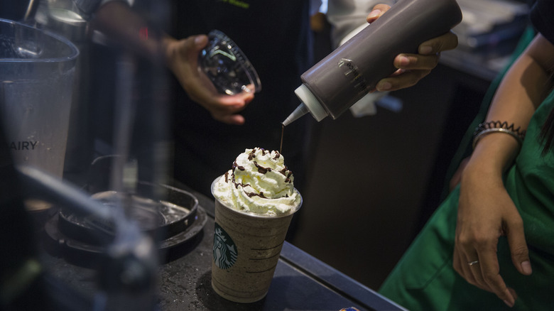 Barista making Starbucks drink