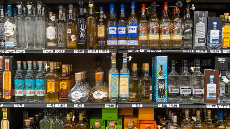 Bottles of tequila sold on shelf.