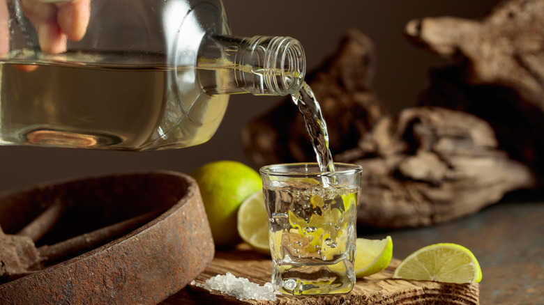 Tequila poured into a shot glass.