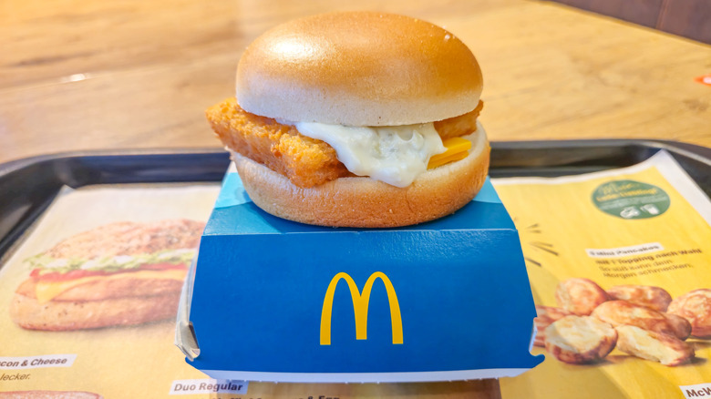 A Filet-O-Fish sits on a McDonald's box.