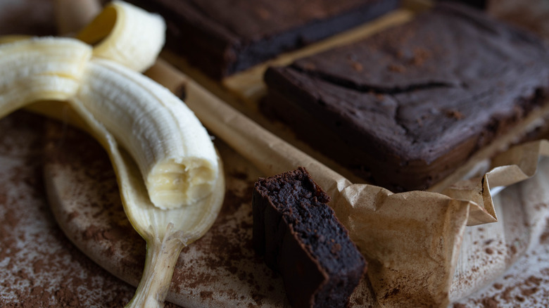 gluten-free brownies sit sliced next to a banana