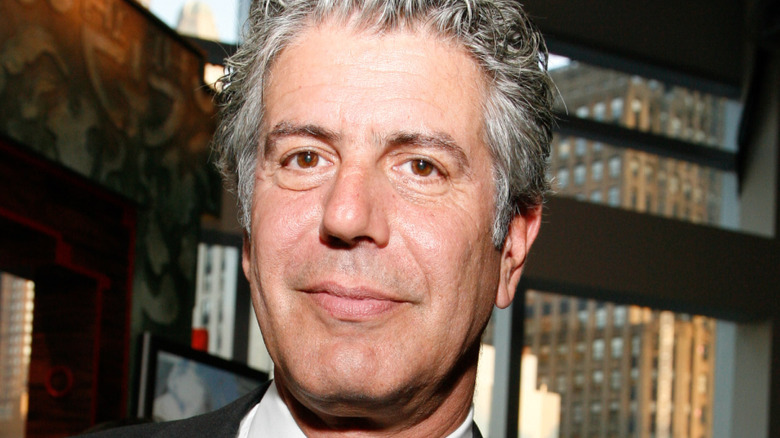 Anthony Bourdain smiling in building