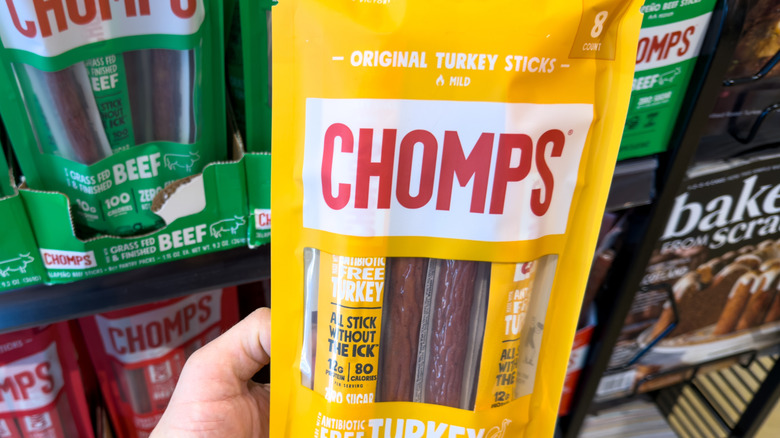 Person holding a bag of Chomps Turkey Meat Sticks
