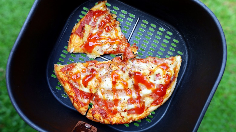 Leftover pizza slices in air fryer basket