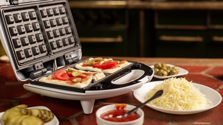 Heating pizza in waffle iron with various extra toppings