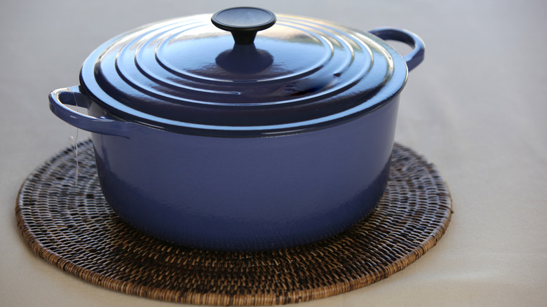 A blue Le Creuset pot on a placemat