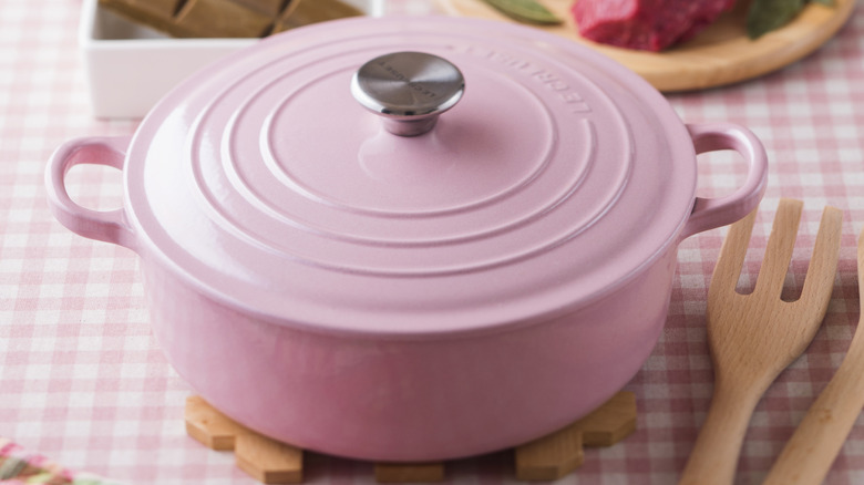 A chiffon pink Le Creuset pot in a kitchen