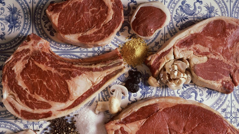 Various large, raw steaks.