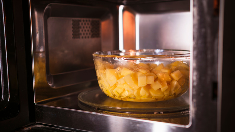 Diced potatoes in a bowl in a microwave.