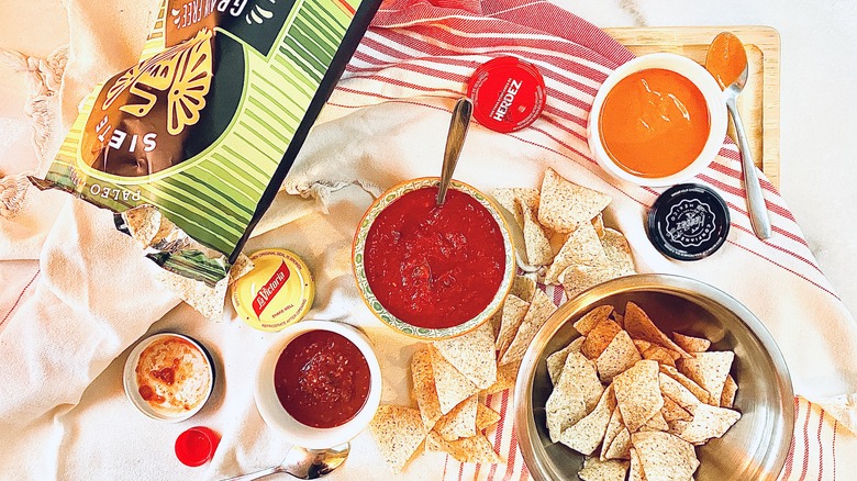 salsa, chips, bowls on table