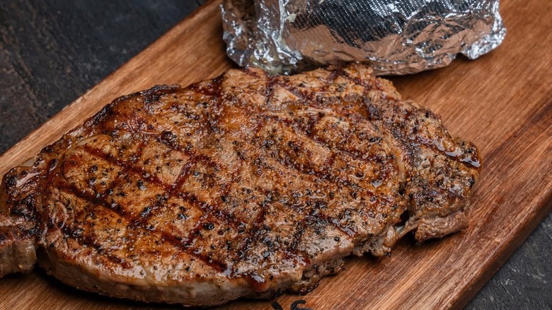 Seasoned steak on a cutting board from Cattleman's Roadhouse.