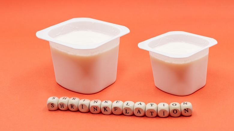 plain yogurt cups on an orange backdrop
