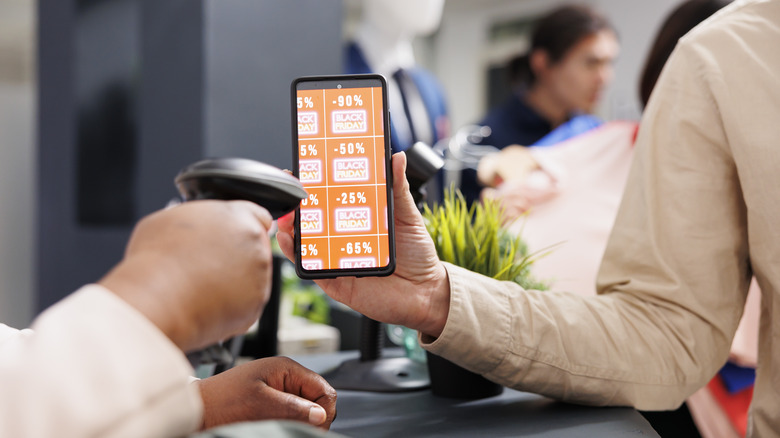 customer using mobile discount code on their smartphone while shopping