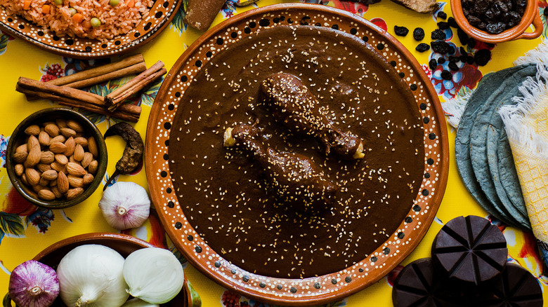 Enchiladas with mole sauce on decorated plate