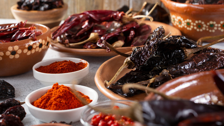 Dried chiles for mole in bowls on table