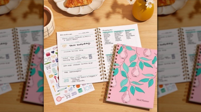 Meal planning book with a pink and green pears design, shown with it opened to pages inside
