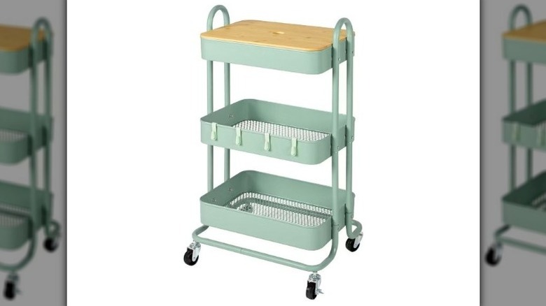 Mint green three-tier rolling cart with a wooden top