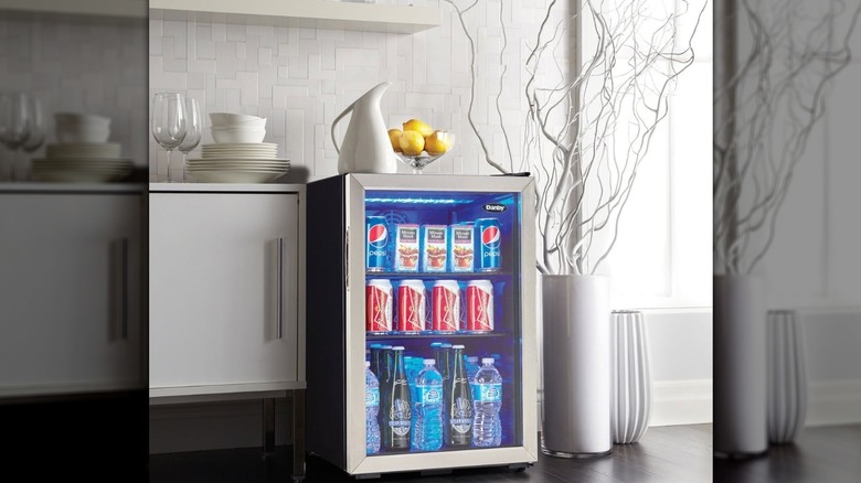 Danby mini fridge with glass door filled with drinks