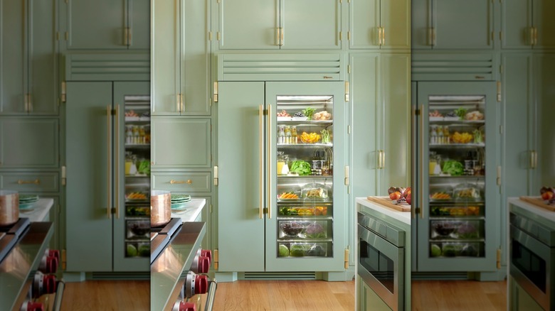 A side-by-side True home refrigerator in sage with brass hardware perfectly matched to the kitchen cabinetry