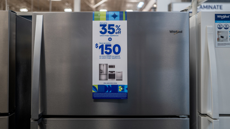 A silver Whirlpool refrigerator in an appliance store