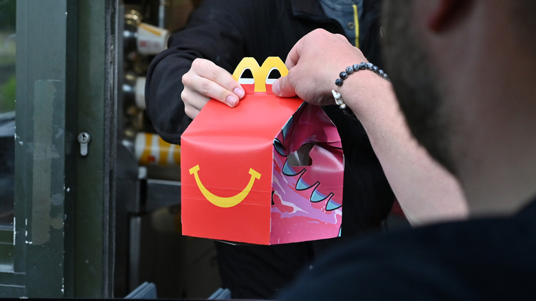 Drive-thru customer receives a Happy Meal.
