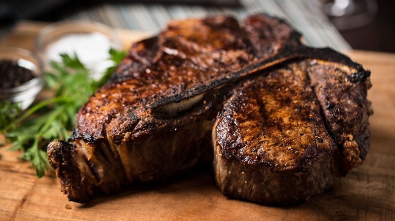 Smith and Wollensky Prime Dry-Aged T-Bone sitting on a cutting board.