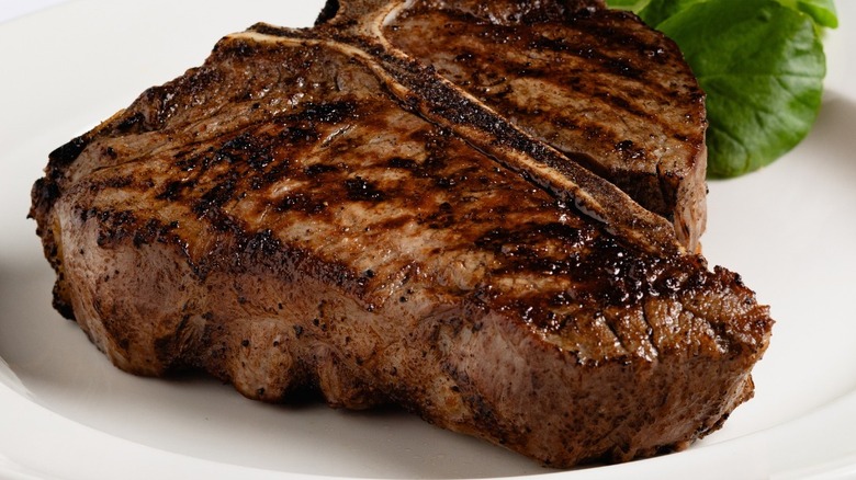 The Capital Grille Bone-In Dry Aged Porterhouse sitting on a white plate.