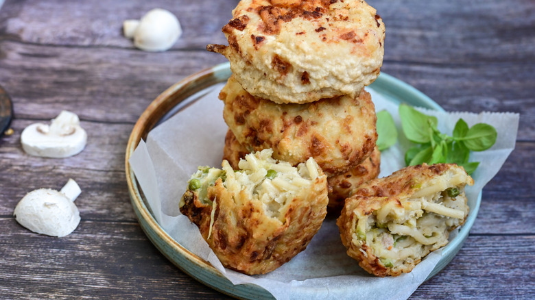 Fried pasta fritters stacked on a plate