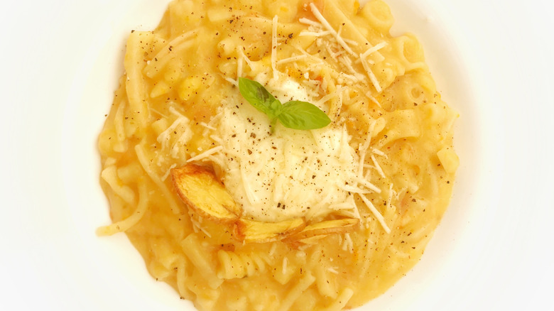 Closeup of pasta and potatoes topped with cheese