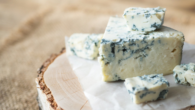 Chunks of blue cheese on a rustic board