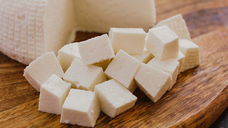 Large wheel of panela cheese with cubes cut out of it