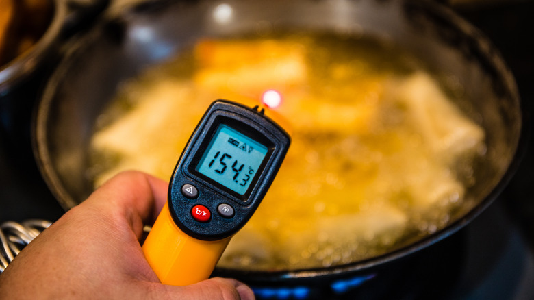 taking temperature of frying pan