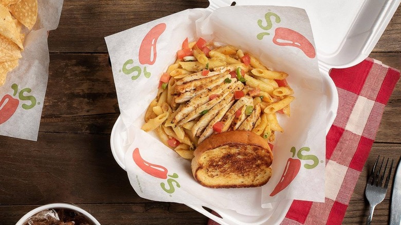 Cajun Pasta with chicken and Texas Toast in a to-go box.