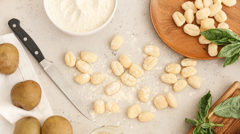 Raw gnocchi on floured surface