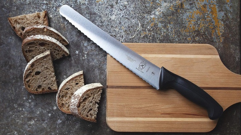 Mercer Millenia Wavy Edge 10 inch bread knife on cutting board with bread