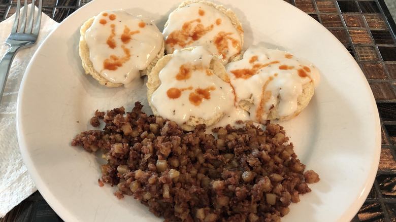 Corned beef hash served with biscuits and gravy