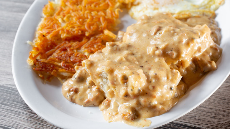 Biscuits and gravy served with crispy hash browns