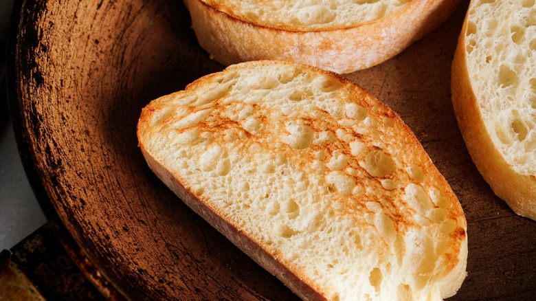 toasted slices of bread on wood surface