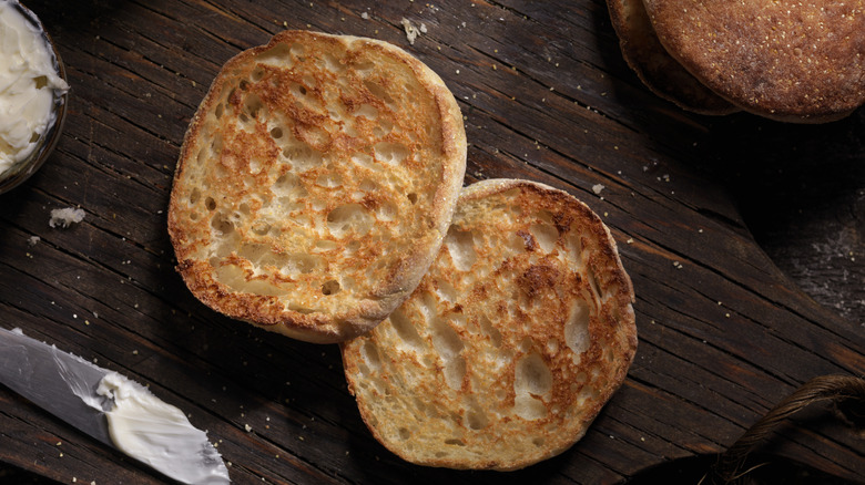 toasted english muffin with butter next to knife