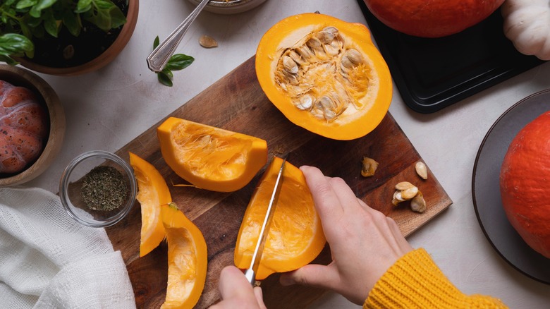 Person cutting a butternut squash